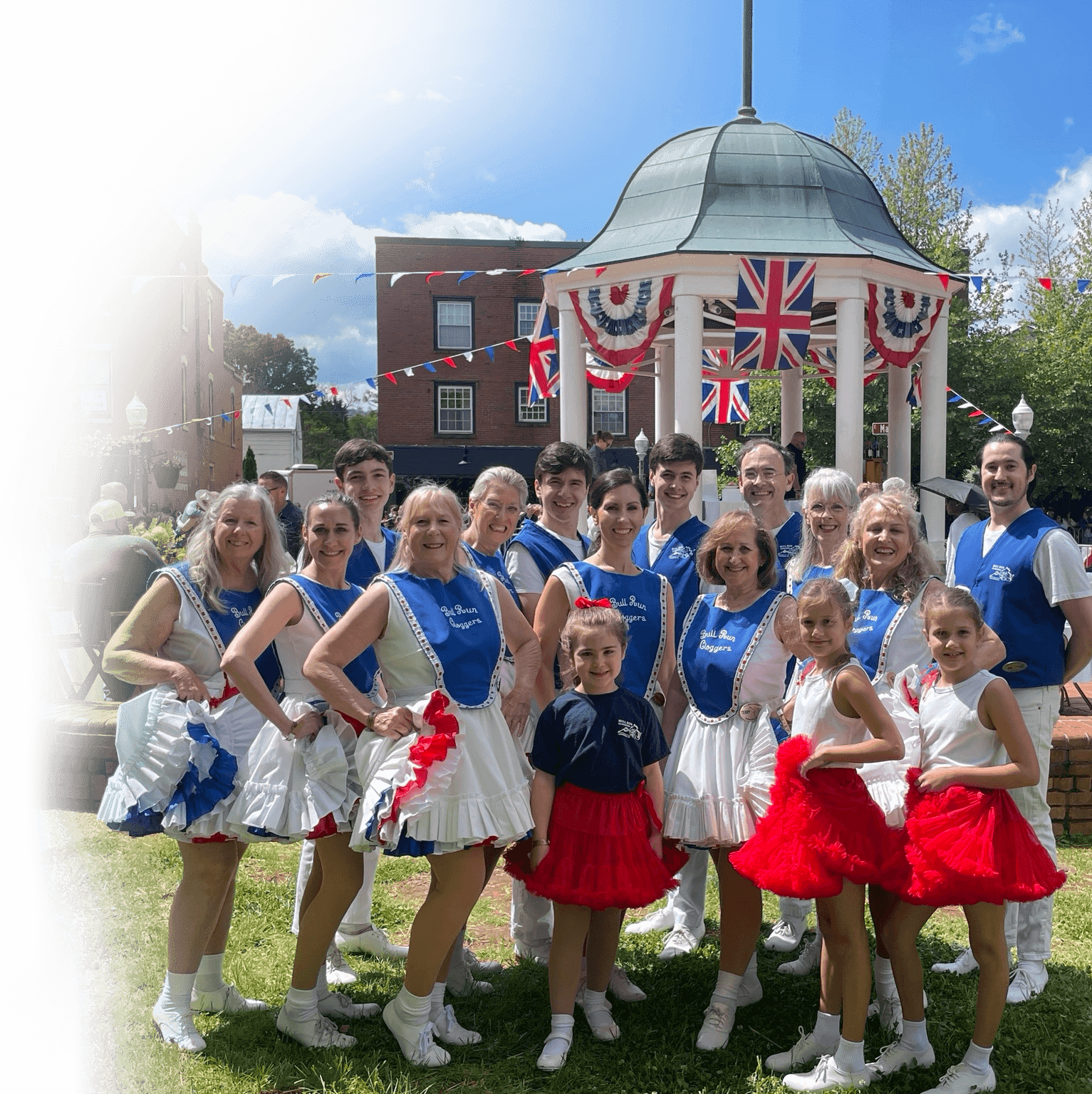 Bull Run Cloggers performing on stage in red, white, and blue costumes.