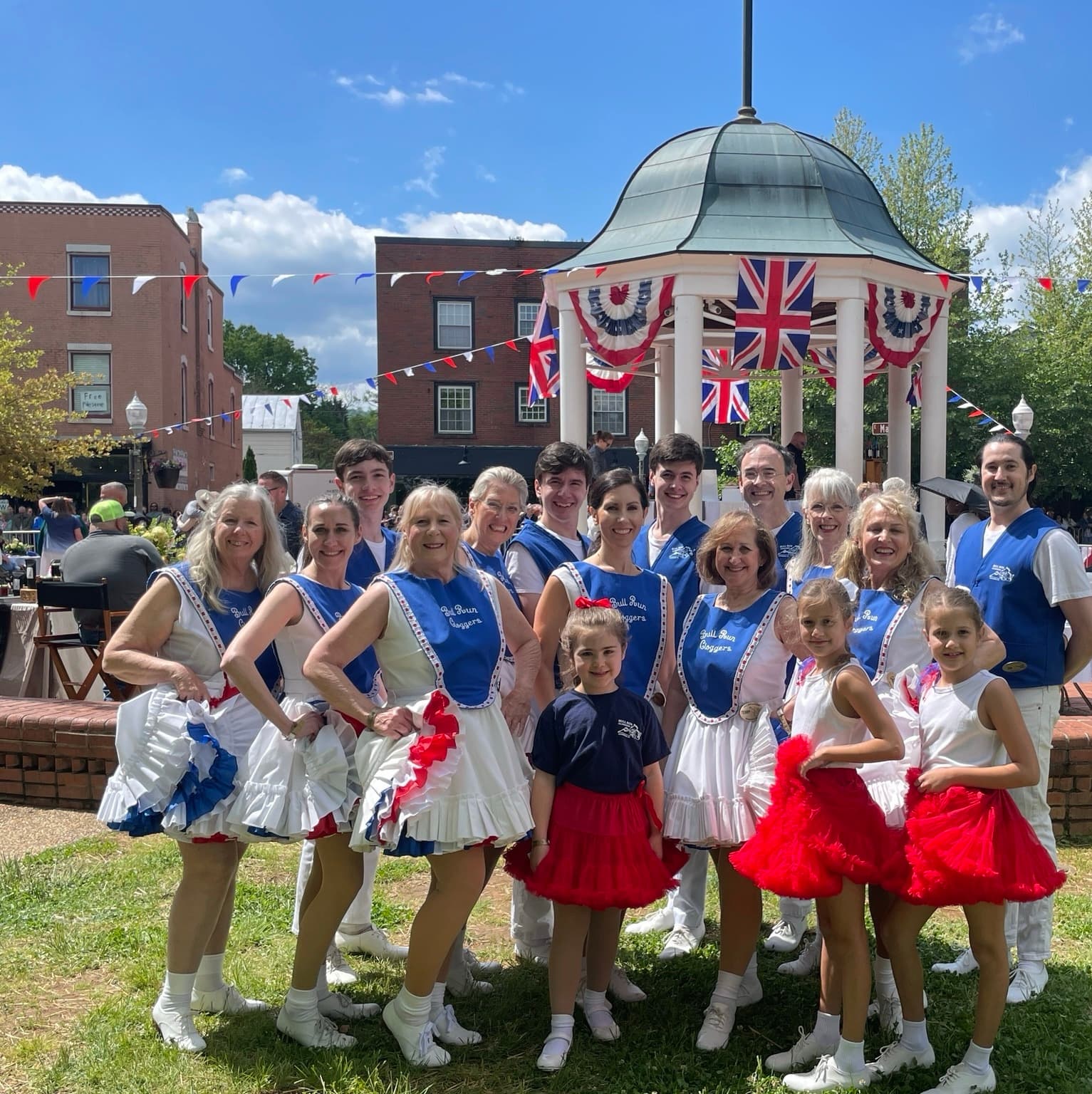 Bull Run Cloggers performing on stage in red, white, and blue costumes.